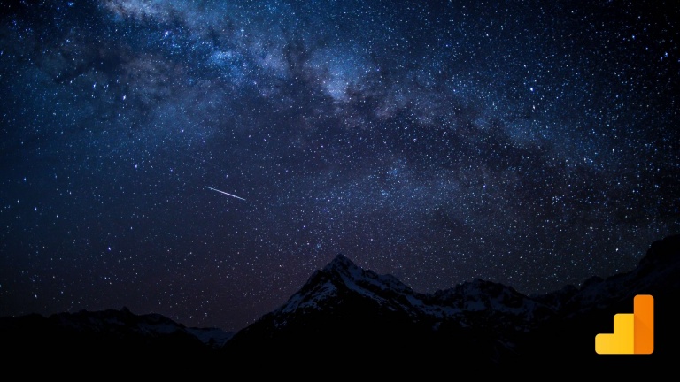 Shooting star over mountains with Google Analytics logo